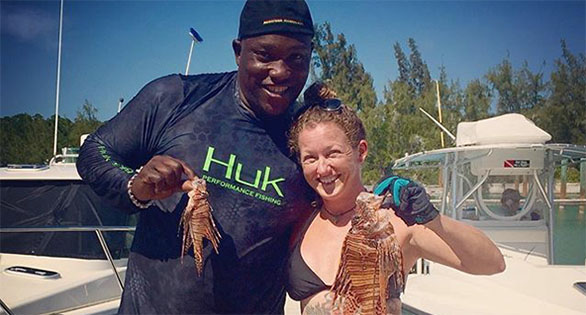 Pro football player appears outfished by Rachel Bowman in a dock scene in the Keys. Source: Lionfish Huntress.