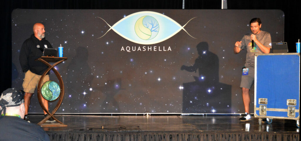 October 8th, 2022 - Jake Adams (right) joins John Hundson on Aquashella Chicago's Fluval Mainstage to offer up an "all in good fun" debate, Freshwater vs. Saltwater. It would be Adams' last time on stage at an aquatic event. Image courtesy Michael Esposito/Aquashella.