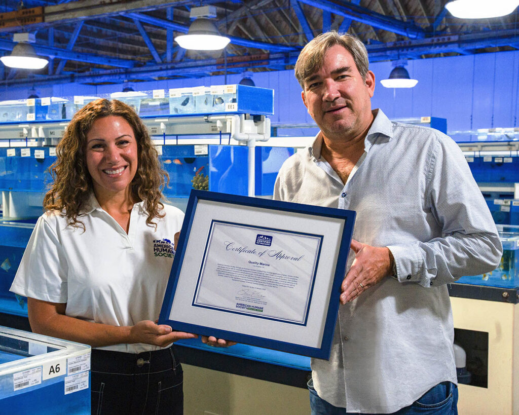 Chris Buerner (right), President and Owner of Quality Marine, receiving the Certificate of Approval from Julie Dyer of the American Humane Society.